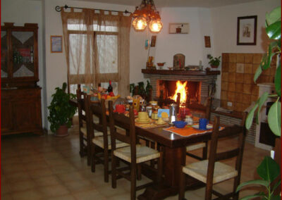 Sala comune con tavola apparecchiata e camino